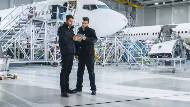 men planning maintenance in hangar